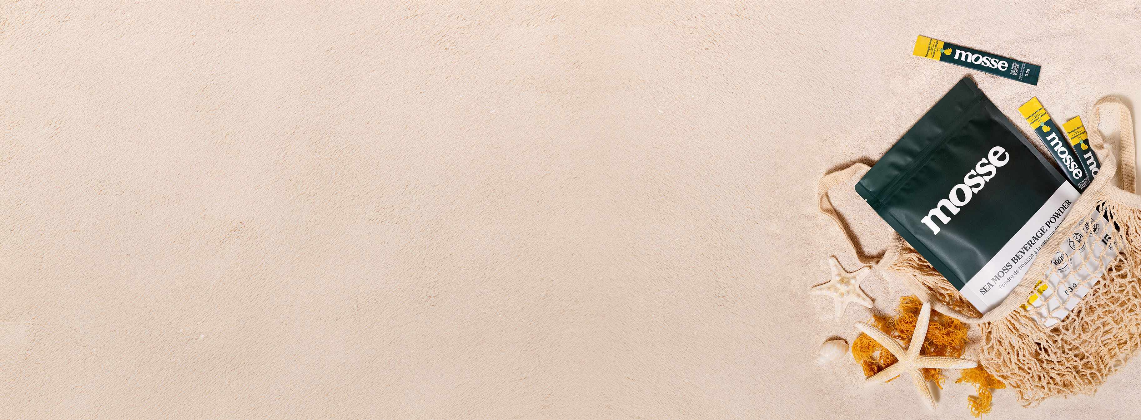 website banner with sea moss beverage powder pouch on sand background